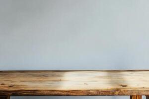 Rustic wooden table against a plain wall backdrop. photo