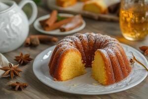 Delicious pound cake, sliced, on a plate with tea and spices. photo