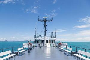 A boat with a white deck and a blue sky photo