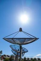 A large metal dish with a sun shining on it photo