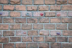 A brick wall with many different colored buttons photo