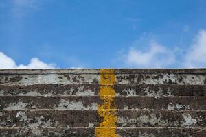 A yellow line on the side of a stairway photo