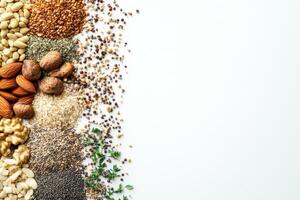 An assortment of organic seeds, nuts, and herbs is displayed on a white backdrop, offering blank space for custom text or branding. photo