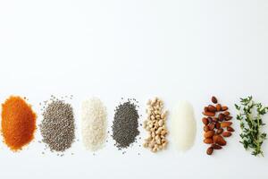 Organic seeds, nuts, and herbs are arranged neatly on a white background, providing ample space for additional text or information. photo