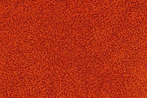 Red fabric material with short pile fluffy and soft texture background. Orange colour surface cloth photo