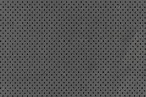 Black color abstract matte material fabric smooth surface with small dots holes pattern background photo