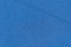Blue color woven hand abstract fabric pattern for background. Plain blue surface textile material photo