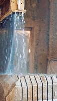 Marble being cooled with water. Marble cooled with water while being cut Vertical video