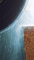 Machine cutting a marble block. Marble sawing machine in a factory from a quarry Vertical video