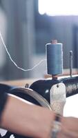 Old sewing machine. Close up of sewing machine and threads Vertical video
