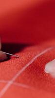 Seamstress working at table in atelier. Close up of woman seamstress making pattern on fabric with chalk Vertical video