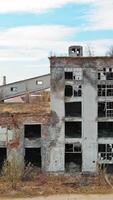 Front facade of abandoned building. Old factory shows the post industrial plight with broken windows Vertical video