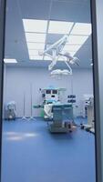 Surgical room with contemporary equipment. Door of the operating theatre opened and camera moving forward. Empty intensive care unit at hospital. Vertical video