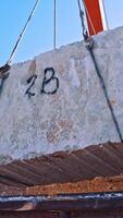 Blocks of marble in quarry. Industrial view of crane loading marble Vertical video