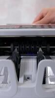 Currency counting machine counts dollar bills. Money counting equipment for paper money calculation. Currency exchange of one hundred dollars. Front view. Vertical video