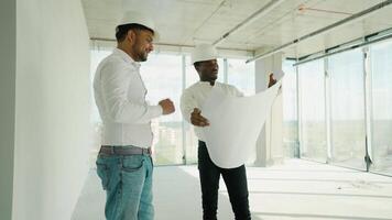 Indian and African architects discussing about the building plan and see how the construction progressive at the construction site video
