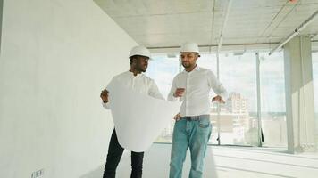 Multiethnic manual worker and engineer discussing on plan video