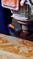Worker cutting stone block. Industrial worker making horizontal cut with electric saw during align marble tiles. Vertical video