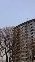 Apartment building with asymmetrical. Stair step architecture in the city downtown. Vertical video