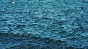Blue sea surface. Background texture of a calm deep blue ocean with ripples on the surface of the sea water video