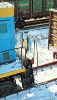 Cargo train platform with container. Scenic aerial view of mixed freight train at platform. Vertical video