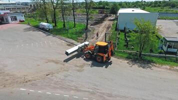 Working machine on construction. Aerial view of tractor working at construction site video