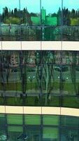 Windows of skyscraper building. Modern office skyscraper with glass windows and reflection. Vertical video