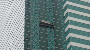 Skyscraper window cleaners in a cradle video
