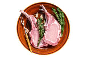 Raw pork chops meat steaks with pepper and salt. Isolated on white background. photo