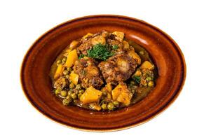 Lamb oxtails ragout with vegetables in a rustic plate. Isolated on white background. photo