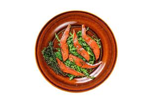 Salad with arugula and smoked salmon fillet slices. Isolated on white background. photo
