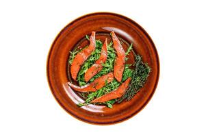 Salad with arugula and smoked salmon fillet slices. Isolated, white background. Top view. photo