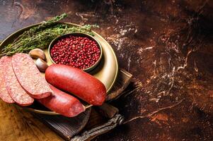 Sliced halal Sucuk beef meat sausage. Dark background. Top view. Copy space photo