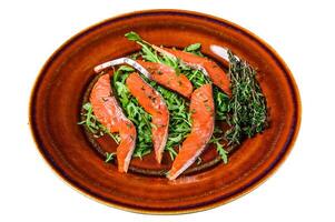 Salad with arugula and smoked salmon fillet slices. Isolated on white background. photo