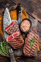 Oyster Top Blade beef meat steak grilled on summer BBQ. Wooden background. Top View photo