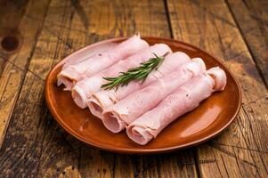 Italian Sliced Prosciutto Cotto ham on plate. wooden background. top view photo
