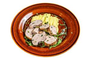Roaast pork tenderloin meat steak on a plate with mash potato. Isolated on white background, top view. photo