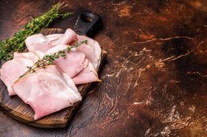 Ham Prosciutto Cotto, Sliced Pork Ham on wooden board. brown background. top view photo