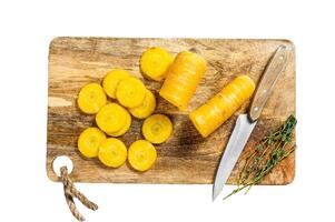 Sliced fresh Yellow carrots without tops, the concept of cooking vegetables. Isolated on white background. Top view. photo
