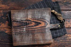 Directly Above view Of Cutting Board On dark Wooden Table. Wooden background. Top view. Copy space photo