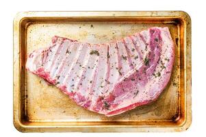 Marinated lamb mutton ribs with herbs and thyme in baking dish. Isolated, white background. photo