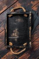 Directly Above view Of wooden tray on dark Table. Wooden background. Top view. Copy space photo