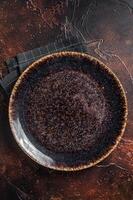 Table setting with vintage empty black plate on rustic wood. Dark background. Top view. Copy space photo