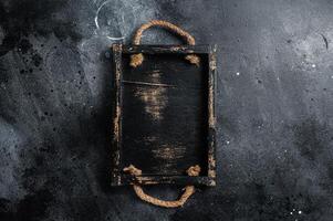 Empty rustic wood tray, healthy cooking background. Black background. Top view. Copy space photo