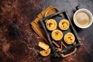 Belem cakes or Pasteis de Belem, Portuguese pastel de Nata Custard Tarts. Dark background. Top view. Copy space photo