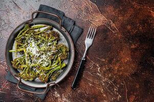 Roast Broccolini cabbage with crispy parmesan cheese. White background. Top view. Copy space photo