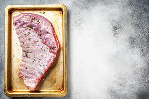 Marinated lamb mutton ribs with herbs and thyme in baking dish. White background. Top view. Copy space photo