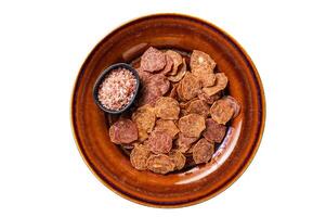 Dried smoked Meat Jerky from beef and pork meat. Isolated, white background. Top view. photo