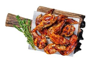 Baked Bbq chicken wings with dip sauce. Isolated on white background, Top view. photo