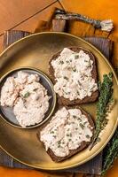 Toasts with Cod liver Spread pate on a plate. Orange background. Top view photo